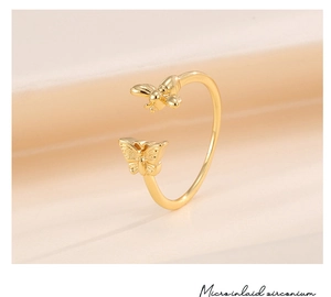 Close-up of adjustable gold ring with micro-inlaid zirconium butterfly and bee details