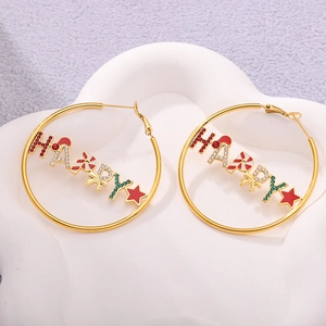 Detail shot of HAPPY Christmas earrings with festive charms on a white ceramic plate