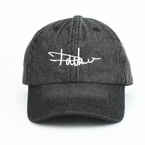 Classic black washed denim baseball cap with white cursive embroidery on front panel