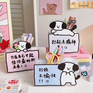 Close-up of cute acrylic desk organizers featuring cartoon dog designs and slogans