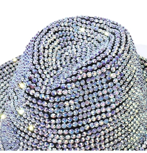 Macro shot of high-density iridescent rhinestones on a vintage fedora party hat