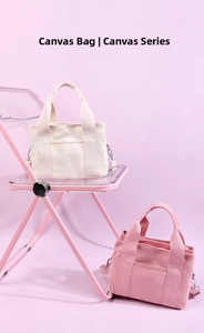Detail of canvas tote bags in cream and pink on a stylish chair display