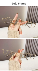 Detailed close-up of golden wavy metal glasses frame with artistic rhinestone accents