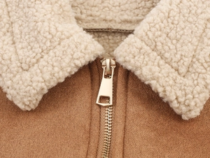 Macro detail of lamb wool collar and gold metal zipper on brown suede bomber jacket