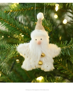 Star-shaped plush Santa Claus ornament with golden bells on a festive Christmas tree branch