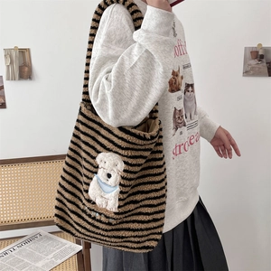 Detail of plush striped tote bag featuring cute dog embroidery and soft fuzzy texture