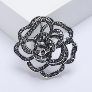 Detail shot of the exquisite black spider lily brooch inlaid with sparkling rhinestones