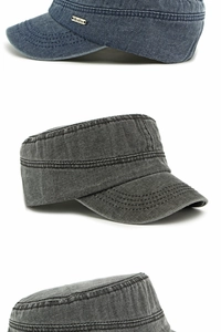 Detail of washed denim flat top army caps with metal branding and reinforced stitching