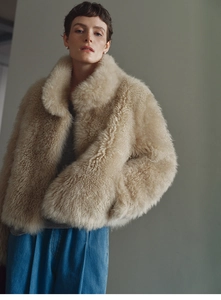 Detailed close-up showing soft beige faux fox fur texture and plush warmth of the vest