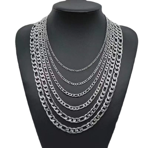 Classic silver stainless steel Figaro chain necklaces layered on a black mannequin