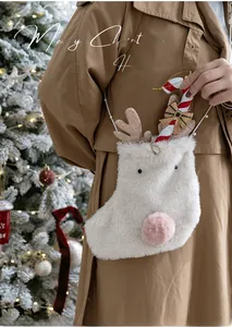 Close-up of white faux fur reindeer Christmas stocking with pink sequined antlers