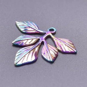 Macro view of a colorful leaf pendant for DIY jewelry in rainbow metal finish