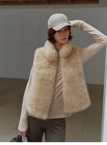 Detail of premium beige faux fox fur vest showing thick plush texture and stand collar