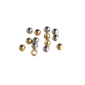 Mix of 5mm gold and silver stainless steel beads with 2mm holes on white background