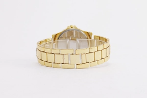 Detailed back view of gold metal watch showing link bracelet and smooth stainless steel case back