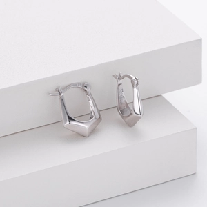 Macro shot of S925 sterling silver stamp on minimalist geometric hoop earrings