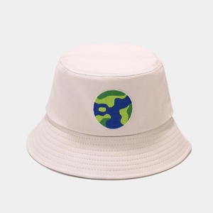 Detail of white bucket hat featuring colorful circular embroidery and stitched brim