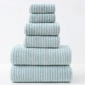 Close-up of blue and white striped cotton towel set stacked in a pyramid arrangement