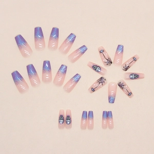 Close-up of Halloween coffin nails featuring purple gradient, cobwebs and cartoon skull masks
