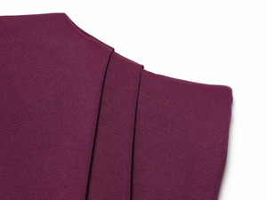 Detailed macro view showing dark purple pleated fabric texture and high-density woven material