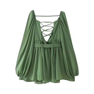 Detail of sage green chiffon dress showing lace-up back and elegant lantern sleeves