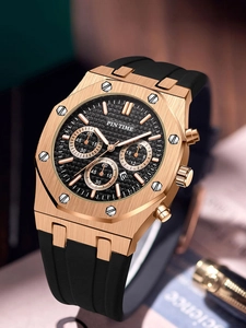 Close-up of gold polygonal chronograph watch with black silicone strap and textured dial
