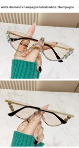 Close-up of cat-eye sunglasses with champagne lenses and white rhinestone embellishments