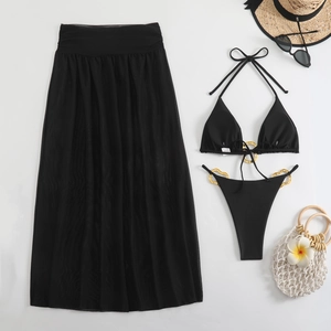 Close-up of black bikini with gold rings, sheer mesh skirt, sunglasses and straw hat