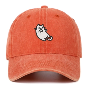 Close-up of vintage washed brick red baseball cap featuring detailed white cat embroidery