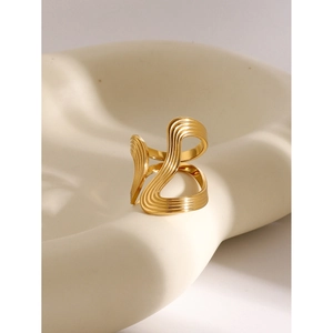 18k gold plated stainless steel irregular wavy ring on a beige geometric tray display