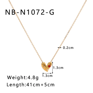 Detail of 18k gold plated heart pendant with red inlay and precise product dimensions