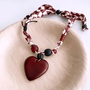 Ethnic style necklace with dark red wooden heart pendant and plaid fabric strap decor