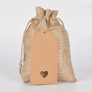 Linen drawstring gift bags with heart-cutout kraft tags for wedding party favors