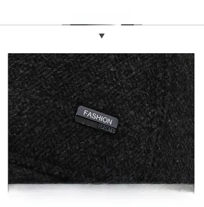 Close-up of black fleece fabric texture with a Fashion Sports woven label on winter cap