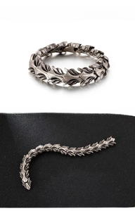 Macro detail of silver dragon scale links on a retro gothic punk style stainless steel bracelet