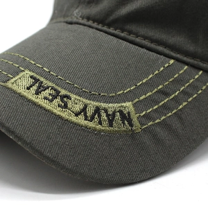 Macro detail of Navy Seal embroidery on army green cotton twill baseball cap visor