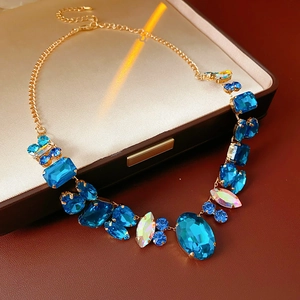 Detail of luxury geometric necklace with blue crystals in a leather jewelry box