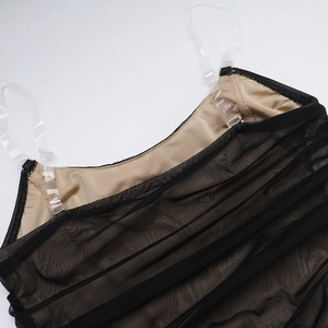 Detail of black mesh ruched dress showing thin straps and contrast lining