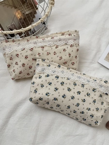 Floral cotton makeup bag with lace trim and zipper closure for cosmetic storage