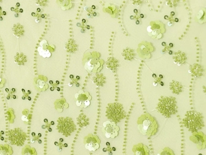 Close-up of light green mesh fabric featuring 3D floral beads and sequins embroidery