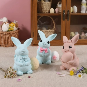 Easter bunny figurines set with colorful eggs and bows for festive home table decoration