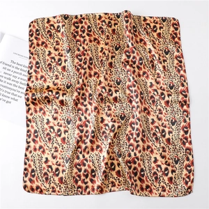 Detail of leopard print silk-like scarf with natural folds and elegant texture