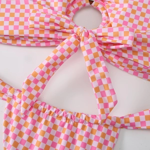Detail view of pink gingham bikini with front bow tie and central O-ring hardware