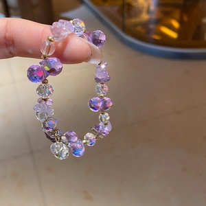 Detailed macro shot of irregular purple amethyst crystal beads and faceted glass jewelry