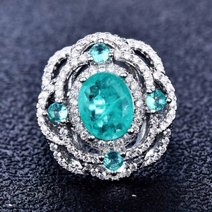 Macro shot of Paraiba blue pear-cut ring with micro-pave diamonds and vintage details