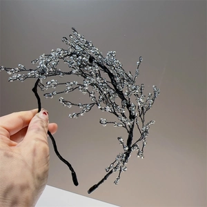 Handmade beaded headband featuring clear crystals and elegant black wire branch design