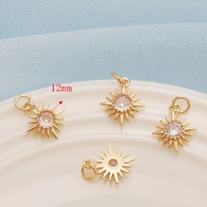 Detailed macro view of 12mm 14K gold-plated sun-shaped charms with sparkling zircon stone