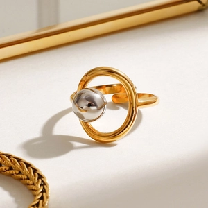 Macro shot of two-tone gold and silver stainless steel ring with floating metal bead