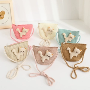 Detailed close-up of colorful mini straw crossbody bags with cute 3D cat decorations