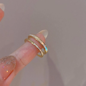 Detail of gold double-layered ring with zircon inlays and mother-of-pearl finish